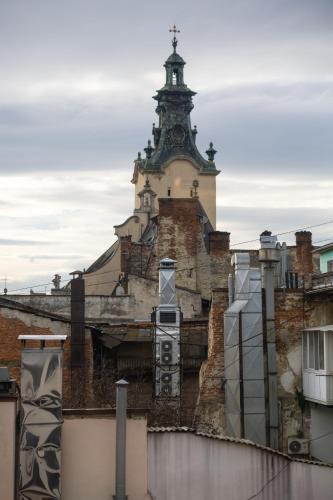 an old building with a tower on top of it at !FEST Hotel Rynok Square in Lviv