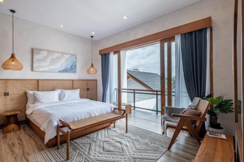 a bedroom with a bed and a balcony at Avyara Villa - Brand NEW, Luxury Tropical with Private Pool in Dalung