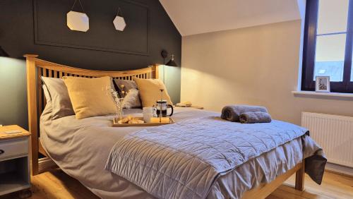 a bedroom with a bed with a blue comforter at The Lookout, Burry Port in Burry Port