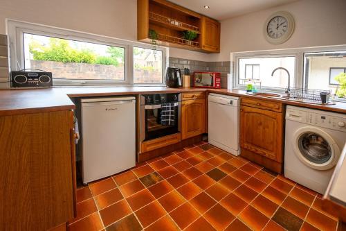 a kitchen with a washer and dryer at Frodo's Folly in Port Talbot