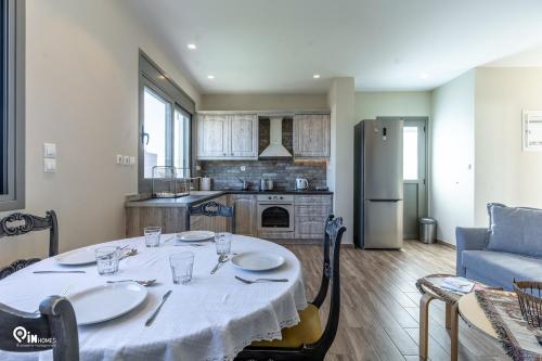 a kitchen with a table and a living room at 'Red Port'Amazing House 5 min from the sea in Rafina