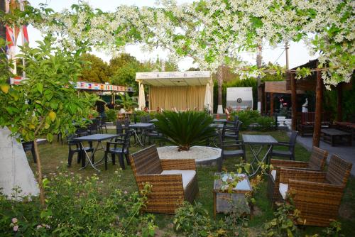an outdoor patio with tables and chairs and trees at Hotel Dream Of Side in Side