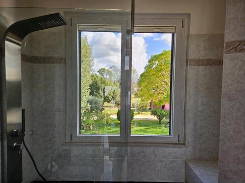 a window in a bathroom with a view of a garden at S'Home - Villa nel Verde fuori Roma - Alloggio Sostenibile in Aprilia
