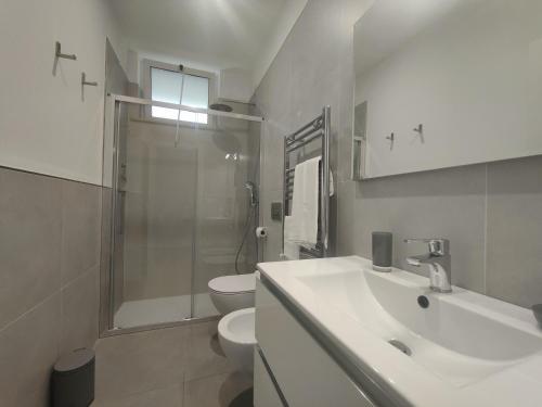 a bathroom with a sink and a toilet and a shower at Homiday - Luminoso in Pineto