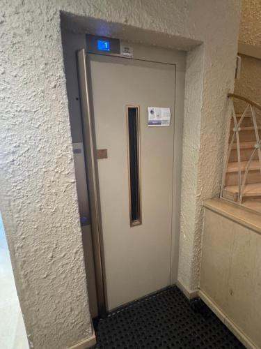 a door in a building with a sign on it at Studio au coeur de Valence 45 in Valence
