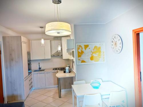 a kitchen with a table and a dining room at Da Vinci Apartment in Tortoreto Lido