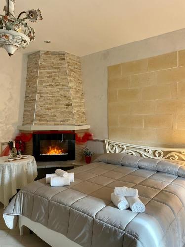 a bedroom with a bed and a fireplace at Re Sole Resort&Spa in Grottaglie