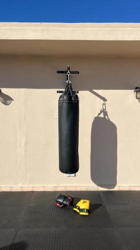 a wall with a punching bag and two lights at Argan House Morocco in Taghazout