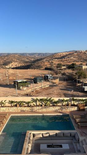 a large swimming pool with a view of a desert at Argan House Morocco in Taghazout