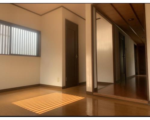 an empty room with a door and a window at Minka -STAY Traditional Japanese houses in Miyoshi