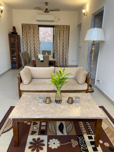 a living room with a couch and a table at A perfect place to be in nature in Kolkata