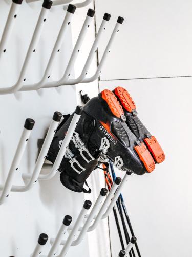 a pair of ski equipment hanging from a rack at Theresian Apartment in Ostružná