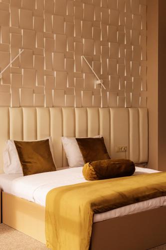 a bedroom with a large bed with a large headboard at Port Plaza EVN in Pʼarakʼar