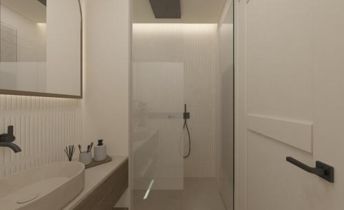 a bathroom with a shower and a sink at The Yard Corfu Boutique Hotel and Spa in Corfu Town