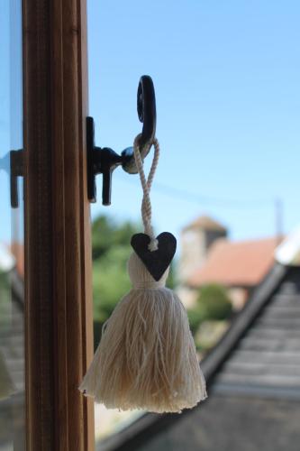 a hat hanging on a window with a rope at The Dovecote - unique self-contained 1bed renovated barn in Saffron Walden