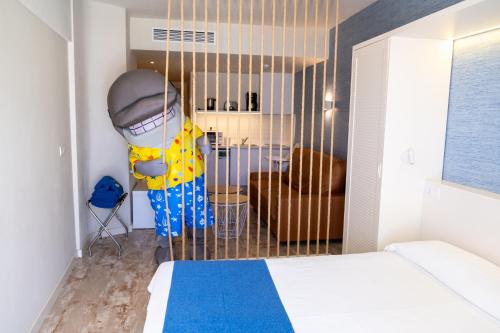 a bedroom with a room with a bed and a mask at HOVIMA La Pinta Beachfront Family Hotel in Adeje