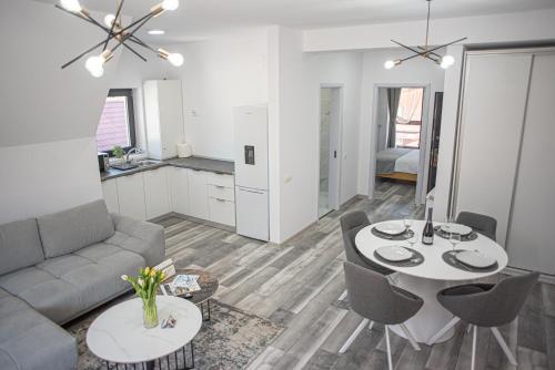 a living room with a couch and a table at Yael Luxury Apartments 5 in Buşteni