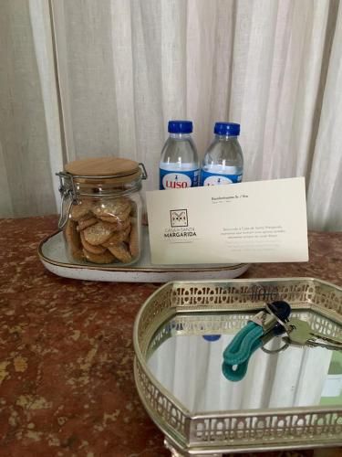 a box of cookies and two bottles of water on a counter at Casa de Santa Margarida in Ponta Delgada