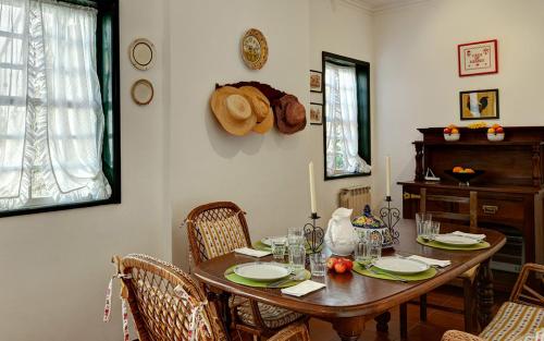 a dining room with a wooden table and chairs at Casa de Abbades in Ponte de Lima