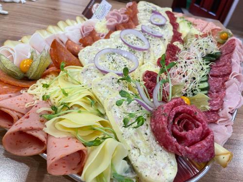 a plate of food with meat and vegetables on a table at Penzion Dori in Diakovce