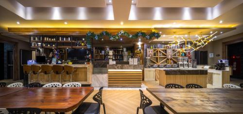 a restaurant with wooden tables and a bar at 凝萃 水岸隱邸-NCH G11 Hotel in Taichung