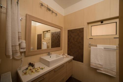 a bathroom with a sink and a mirror at Luxurious Private Villas Gouves in Gouves