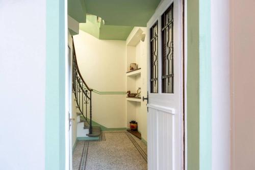 a hallway with green and white walls at One Only Losone Suite in Losone