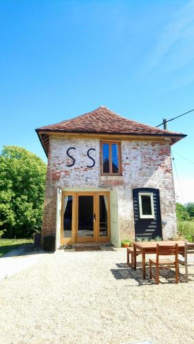 a brick building with the word sss written on it at The Dovecote - unique self-contained 1bed renovated barn in Saffron Walden