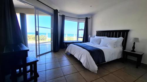 a bedroom with a bed with a view of the ocean at 7 Uvongo Breeze in Margate