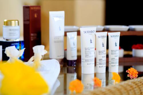a group of bottles of skin care products on a table at Savoy Seychelles Resort & Spa in Beau Vallon