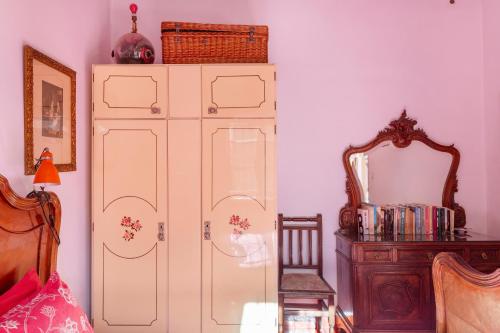 a large white cabinet in a room with a mirror at Casica de Perintín in Ojós