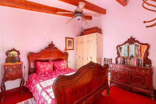 a bedroom with a bed and a dresser and a mirror at Casica de Perintín in Ojós