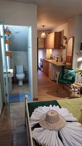 a living room and kitchen with a table in a room at Petite Apt with patio at Garitsa! in Corfu