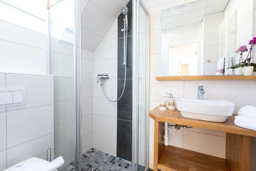un baño con ducha y lavabo en Ferienhaus Naase App 4, en Norderney
