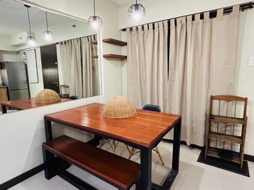 a dining room with a table and a chair at The Mindful Home - 2BR Cozy Condo near NAIA in Manila