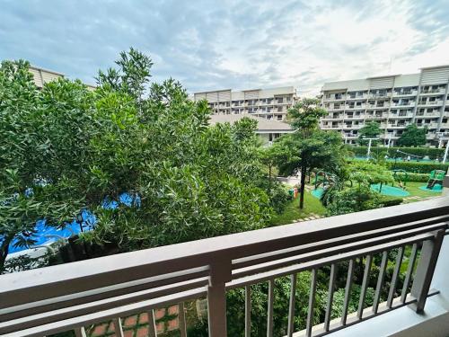 a balcony with a view of a resort at The Mindful Home - 2BR Cozy Condo near NAIA in Manila