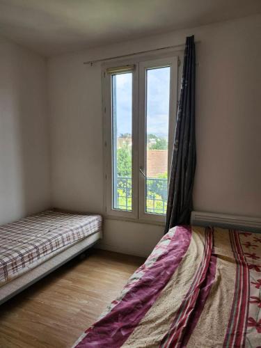 Ένα ή περισσότερα κρεβάτια σε δωμάτιο στο Paris Appartement Near 12Univ