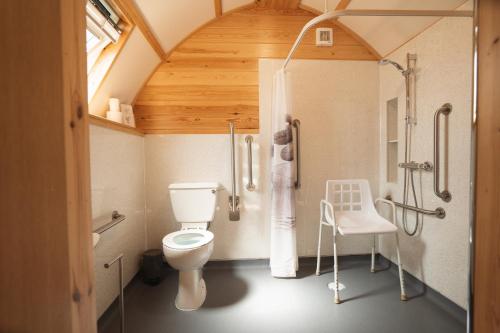 a bathroom with a toilet and a shower at Shellstone by Wigwam Holidays in Tenby