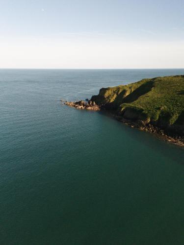 an aerial view of an island in the ocean at Shellstone by Wigwam Holidays in Tenby