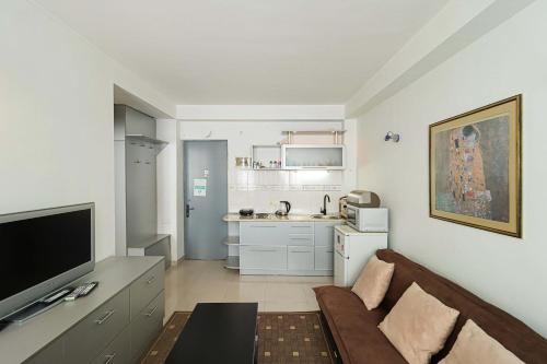 a living room with a couch and a kitchen at 1BR Apartment in Gudauri in Gudauri