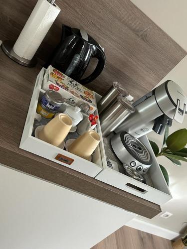 a kitchen counter with a coffee machine in a drawer at La Pause Roséeenne in Rousies