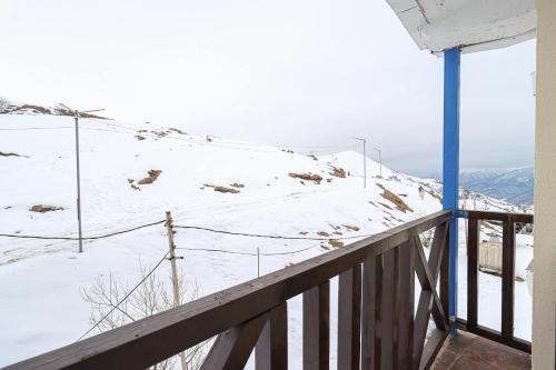 a view of a snow covered mountain from a balcony at 1BR Apartment in Gudauri in Gudauri