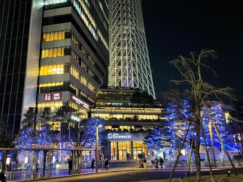 a tall building with christmas lights in front of it at YMK Oshiage 5B in Tokyo