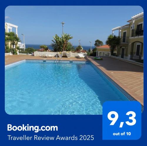 a picture of a swimming pool in front of a building at Encantador T1 praia Senhora da Rocha - Algarve in Porches