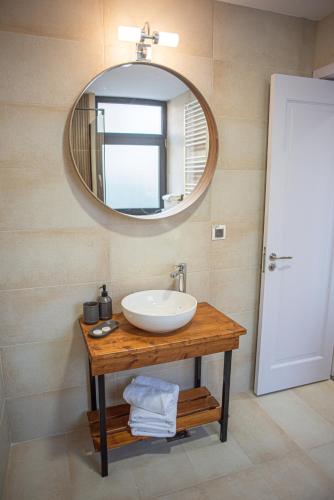 a bathroom with a sink and a mirror at Yael Luxury Apartments 5 in Buşteni
