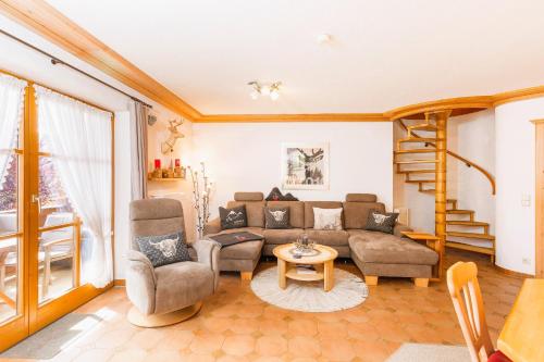 a living room with a couch and a table at Ferienwohnung Elisabeth in Reit im Winkl