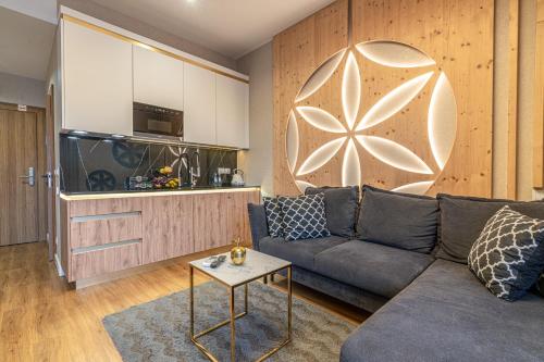 a living room with a couch and a table at Aparthotel Tatrzański SPA in Białka Tatrzanska