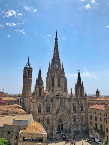 a large cathedral with towers and a blue sky at Hotel Continental Palacete in Barcelona