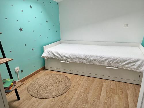 Ce lit se trouve dans un dortoir doté de parquet. dans l'établissement Charmante maison Drômoise, à Pierrelatte