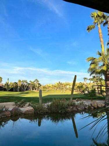 a view of a golf course with palm trees and a pond at Desert Springs Golf Course and Resort, Almería, Spain, 11 The Powderhorn in Cuevas del Almanzora
